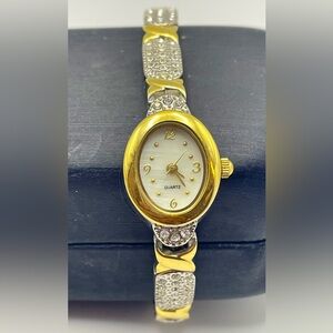 Elegant Gold Tone Cross and Silver Crystal Quartz Oval Watch. Size 7 1/2 inches